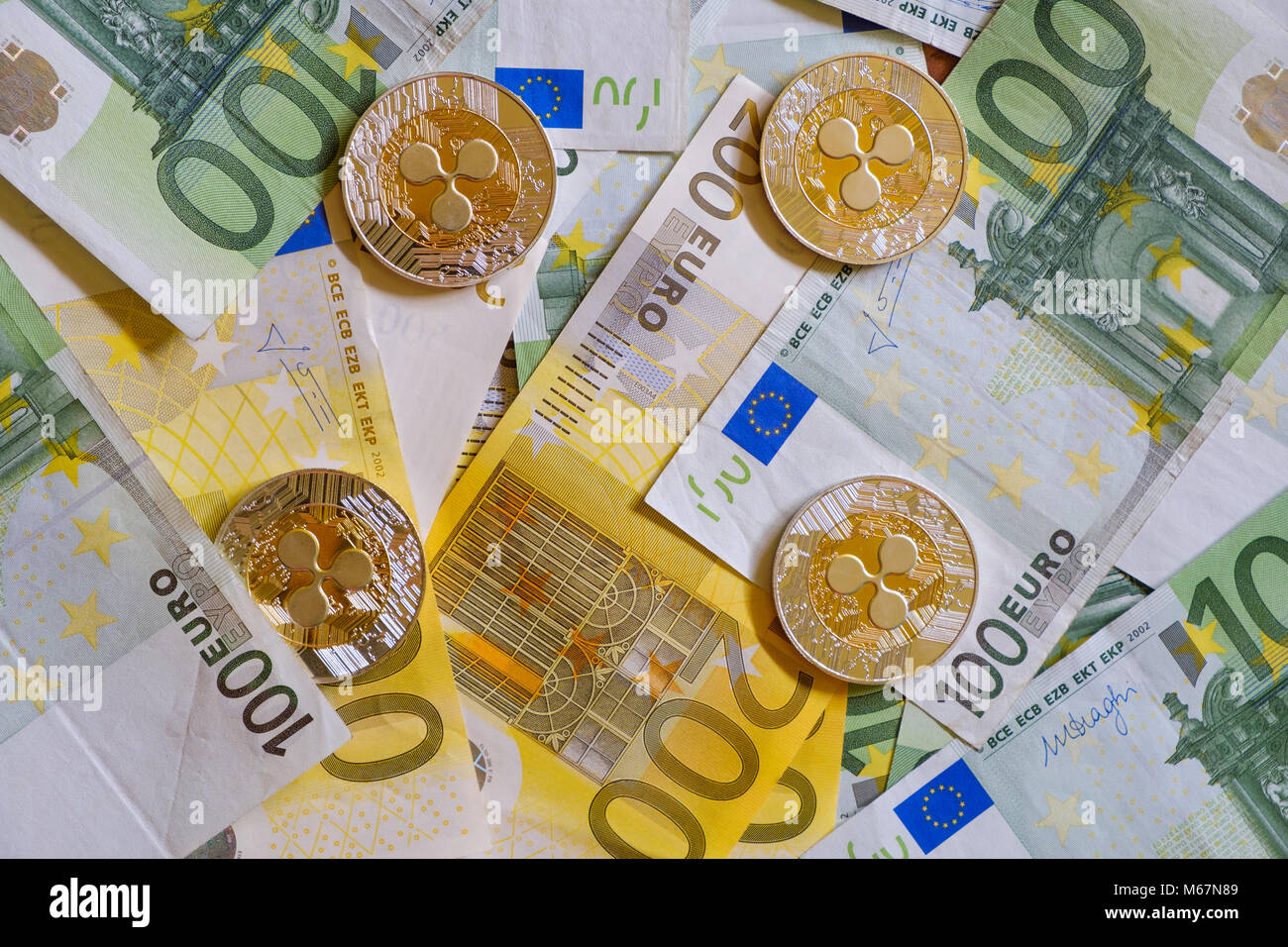 Ripple coins, Crypto currency and Euro banknotes, virtual money Stock Photo