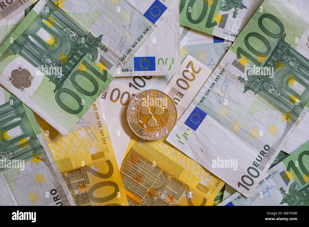 Ripple coins, Crypto currency and Euro banknotes, virtual money Stock Photo