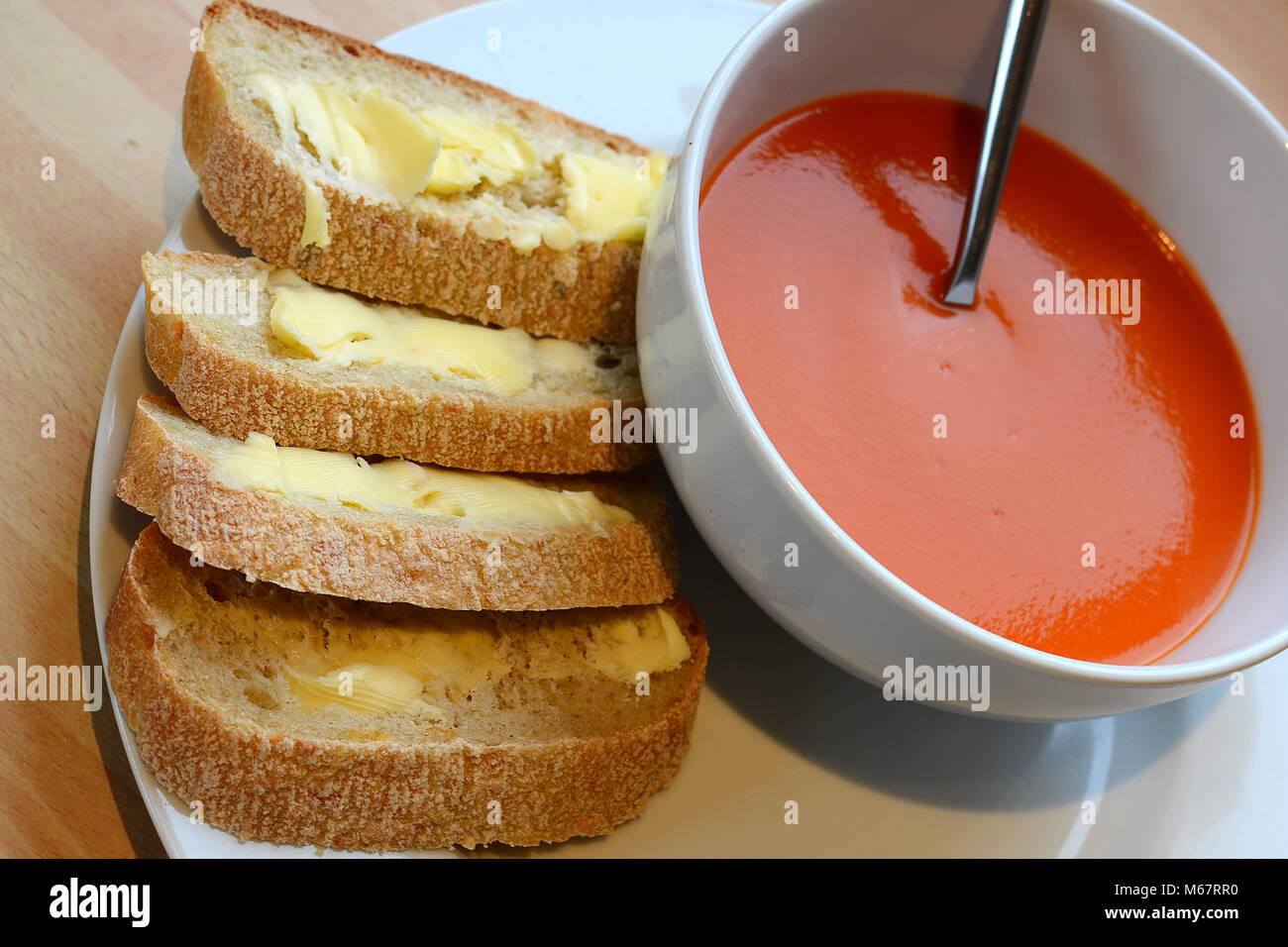 tomato soup with rustic bread Stock Photo Alamy