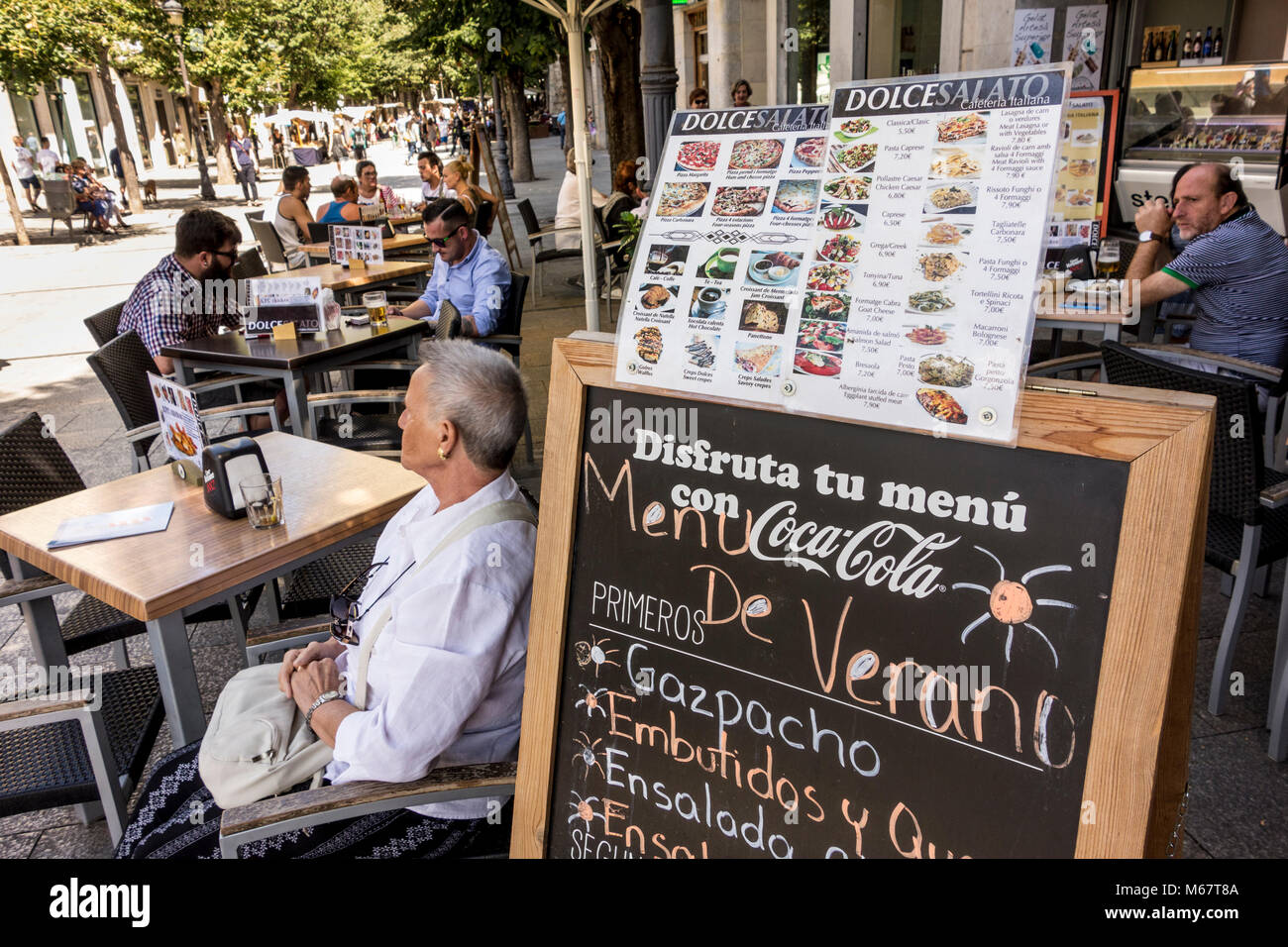 People relaxing at pavement cafe on hot summer day, Rambla de la Llibertat, Girona, Catalonia, Spain Stock Photo