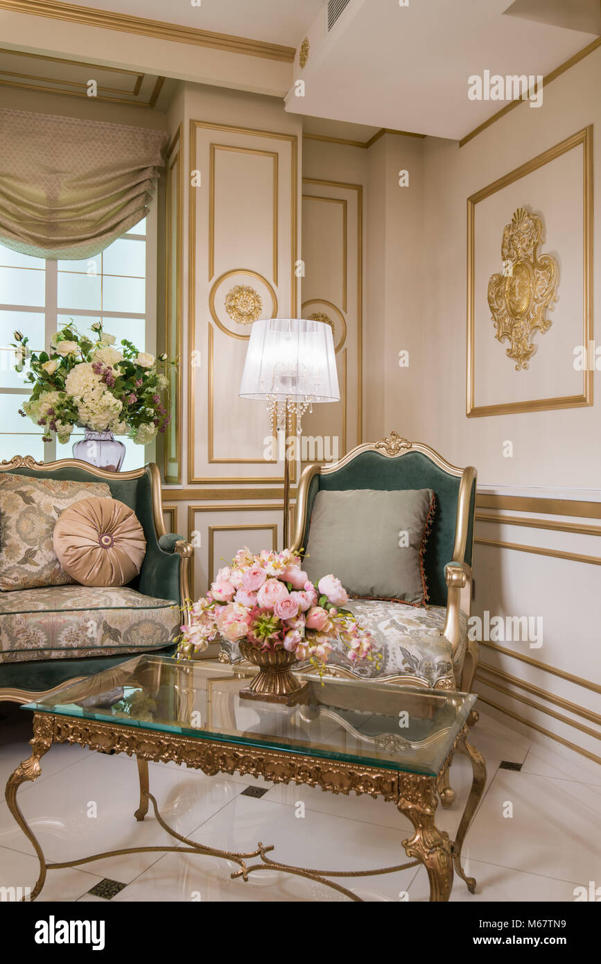 Classic armchair in vintage living room Stock Photo - Alamy