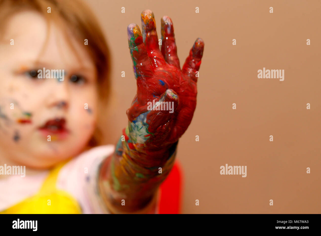 A two year old baby girl painting with water colour based paints Stock Photo Alamy