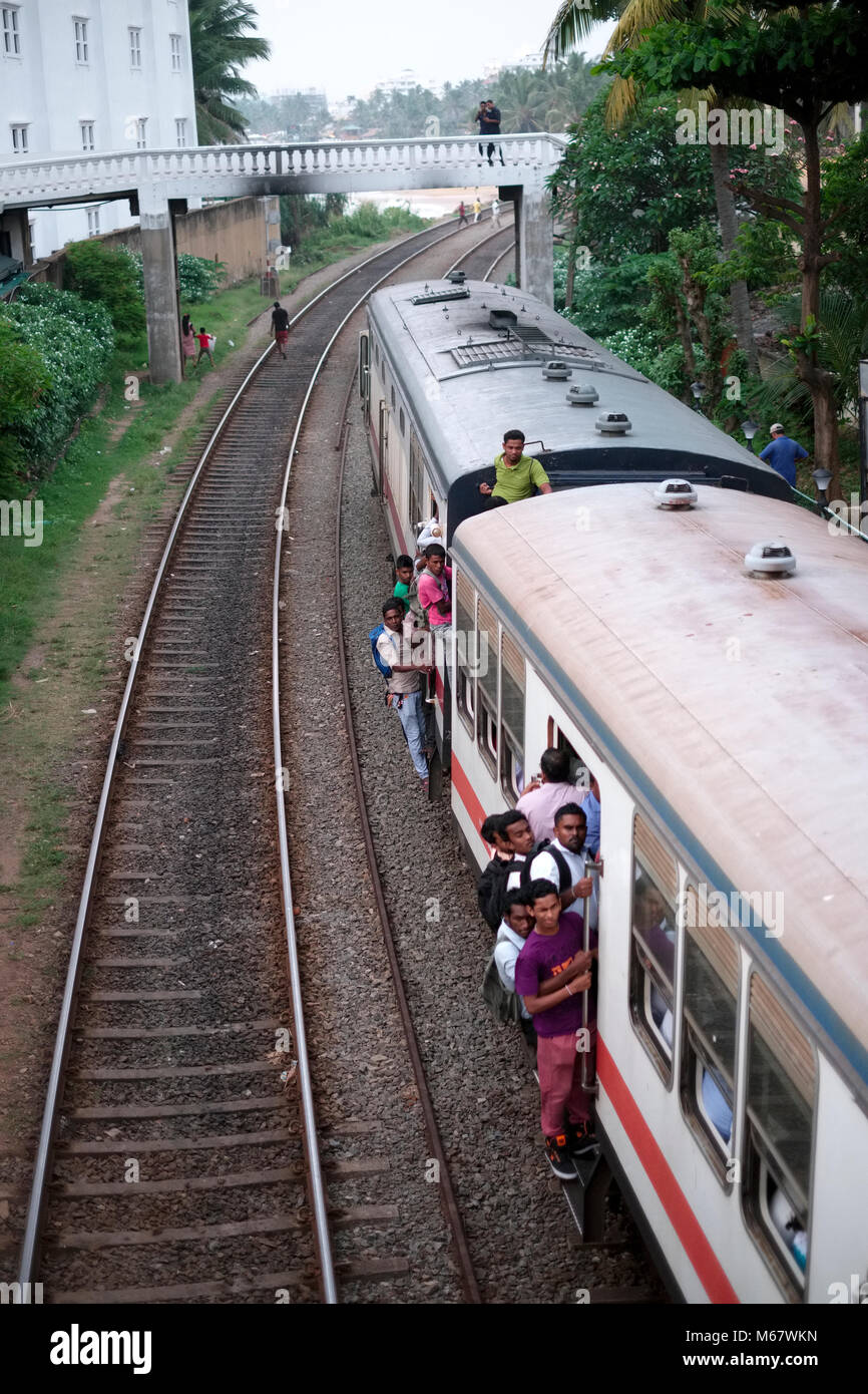 Passengers on the train approaching Mount Lavinia station near Colombo