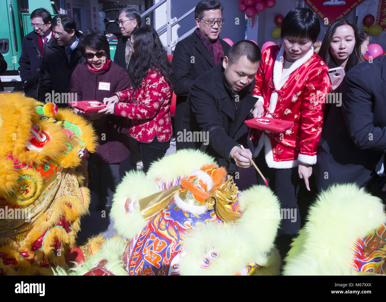 Chinese New Year, Brooklyn, NY. In traditional southern lion dance, before the ‘lions’ do their performances, the ‘animal’ must be blessed by an eye opening or eye dotting ceremony. The red color is used because the color is associated with fire, life and good luck or fortune. Stock Photo