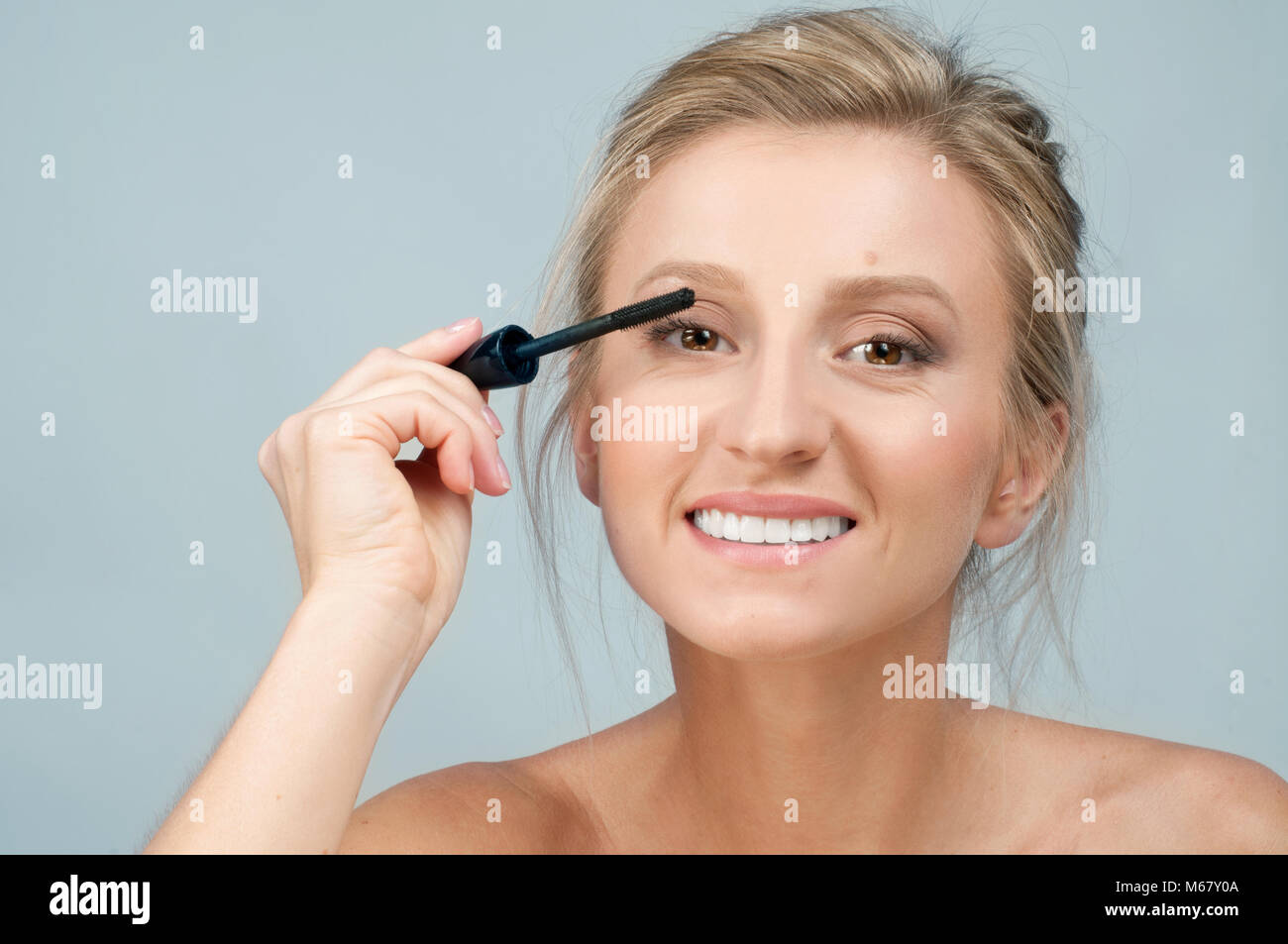 Beauty makeup and cosmetics. Mascara applying closeup. Mascara brush