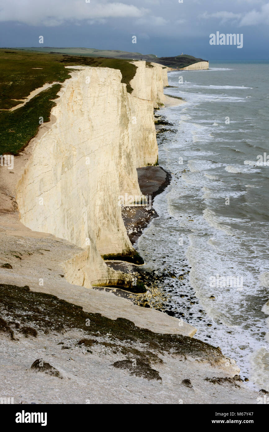 The cliffs of Seven Sisters with Belle Tout lighthouse in the background, on the Sussex coast on the South Downs Way. Stock Photo
