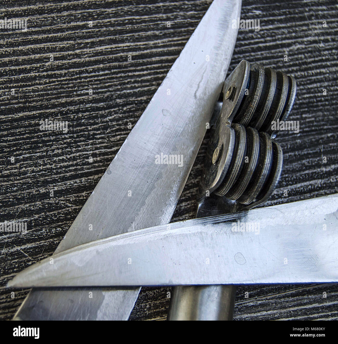 Knives stands next to the blade grinding tools, knife sharpening tool, blunt blades, sharpening