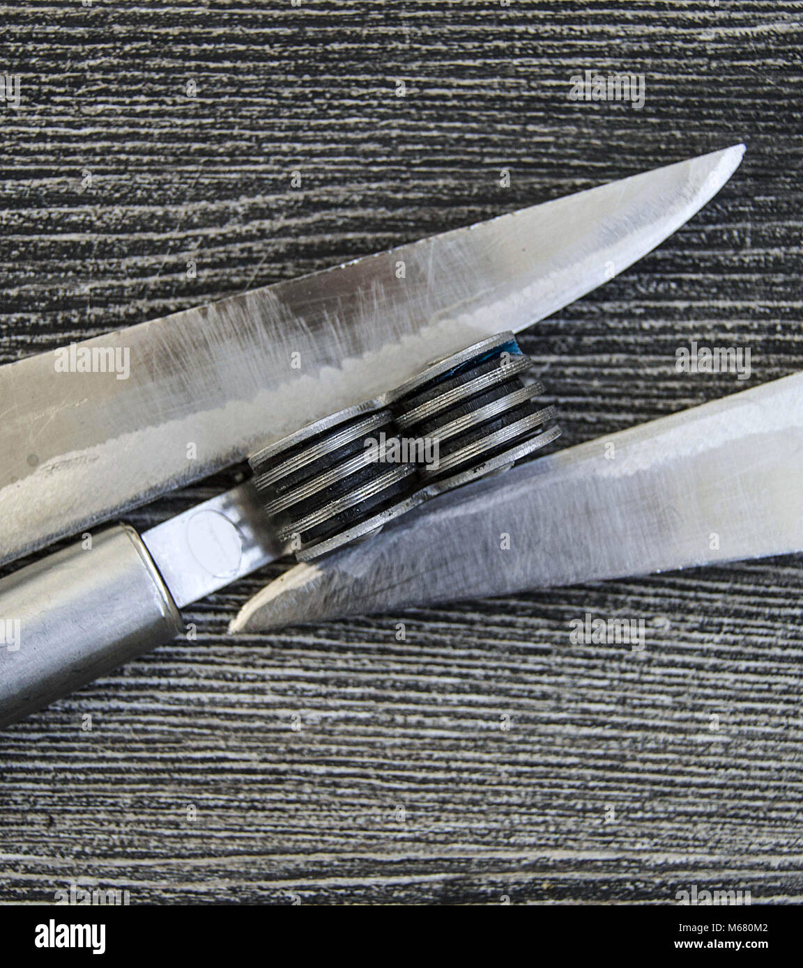 Knives stands next to the blade grinding tools, knife sharpening tool