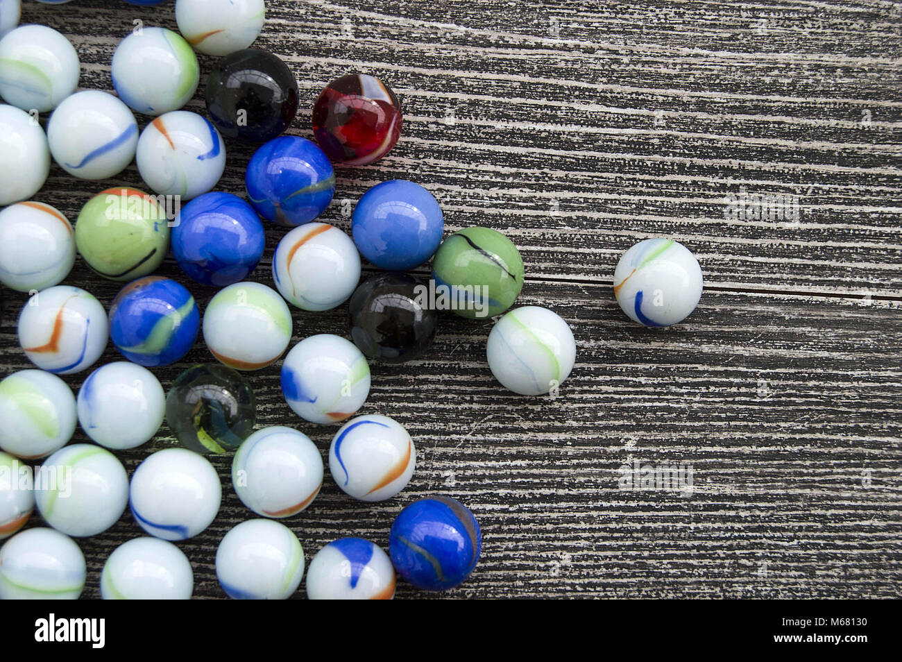 Purey A baby playing with glass marbles, colored glass marble, hundreds of ...