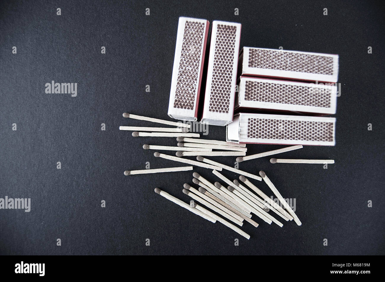 there is a matchbox with a black background, and there are dozens of