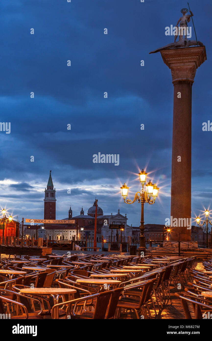 Empty cafe chairs at St. Mark's Square in Venice, Italy just before dawn Stock Photo