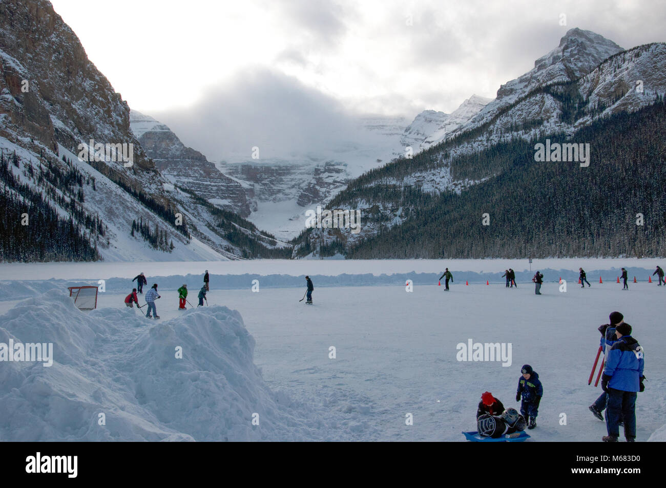 People ice skating on the frozen surface at Lake Louise in Banff
