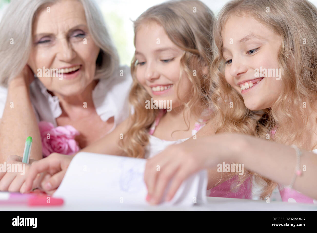 Senior woman with girls drawing Stock Photo
