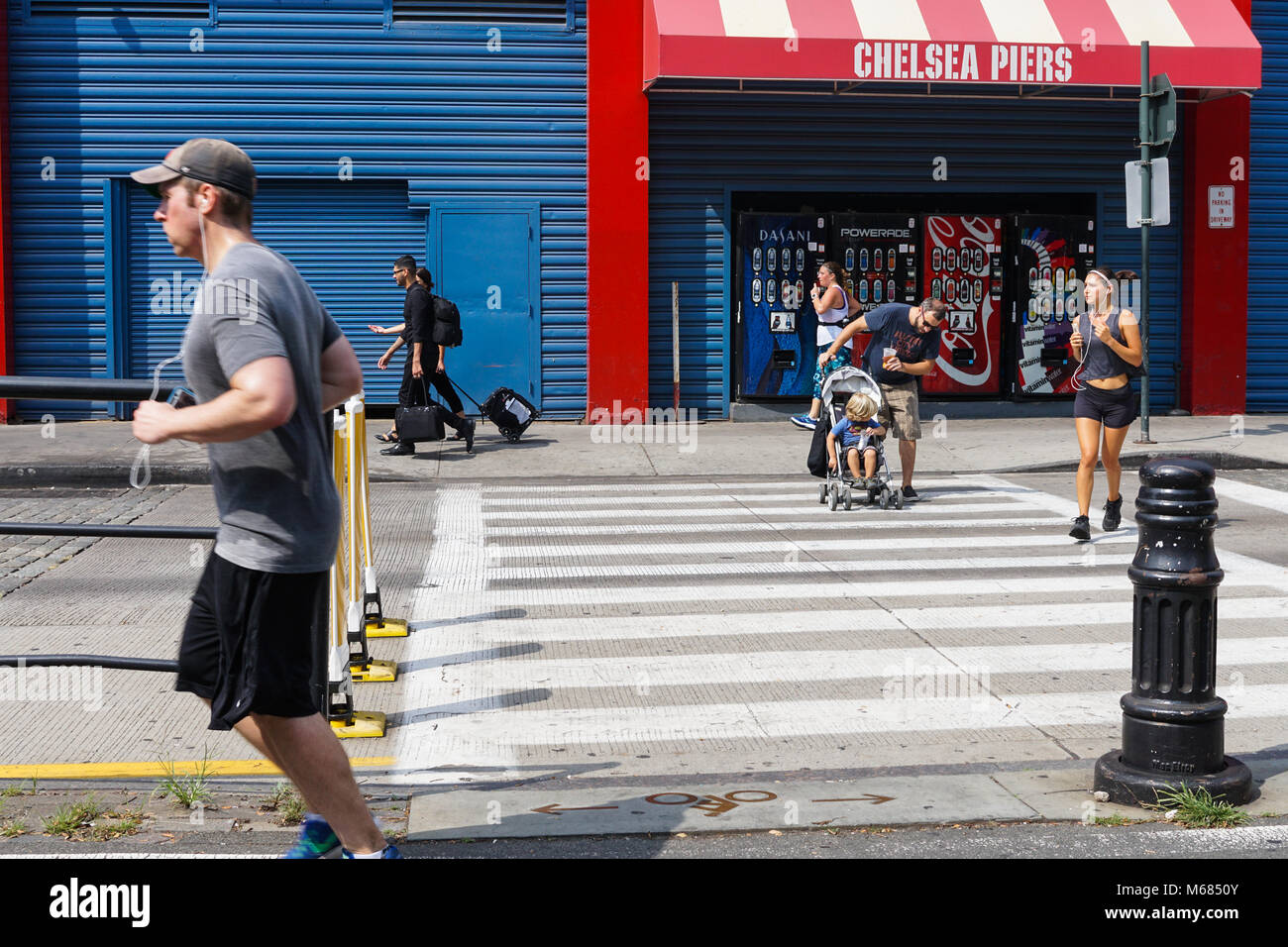 People running and strolling near Chelsea Piers in NYC. Stock Photo
