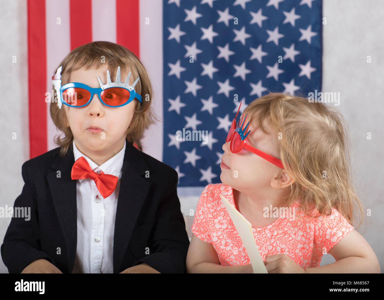 Boy and girl in front of American flag. Closeup Stock Photo - Alamy