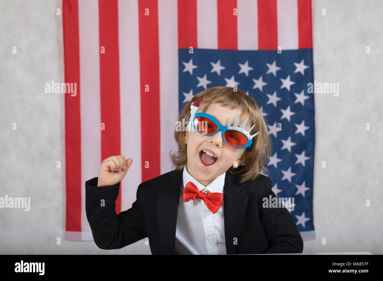 Boy and girl in front of American flag. Closeup Stock Photo - Alamy