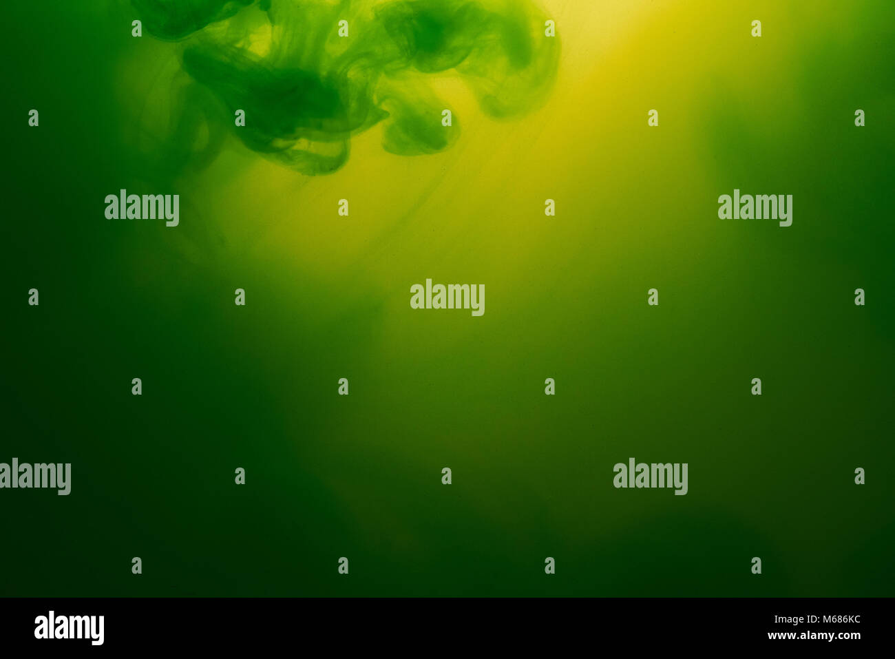 Green and yellow mixed ink background. Watercolor liquid paint mix ...
