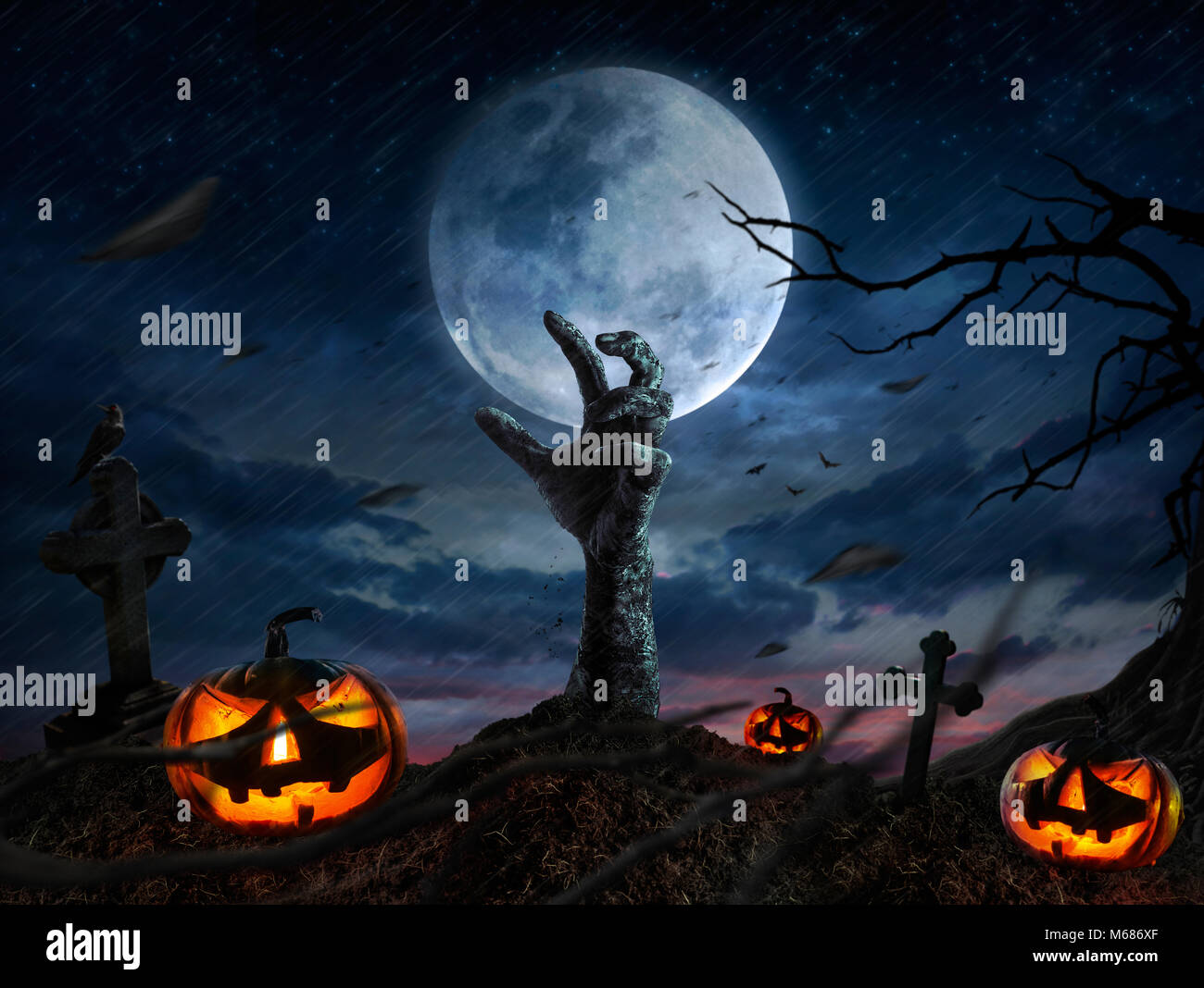 Zombie hands rising in dark Halloween night. Stock Photo