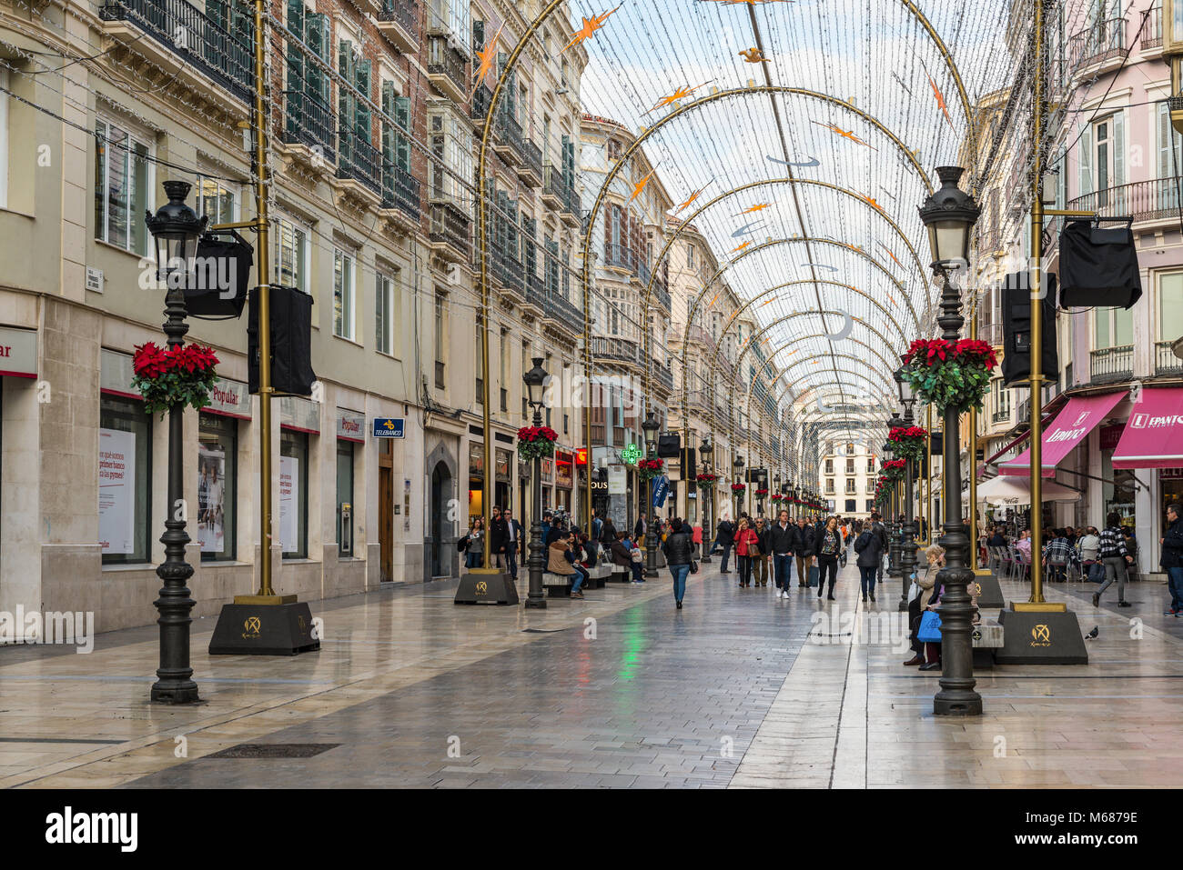 Malaga, Spain - December 7, 2016: People walk along pedestrian Larios Street decorated for Christmas in downtown of Malaga, Andalusia, Spain. Stock Photo
