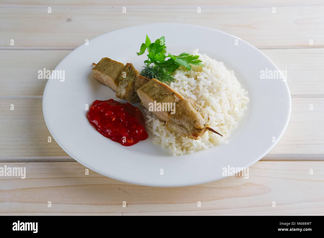Pork shaslyk with rice and tomato sauce Stock Photo Alamy