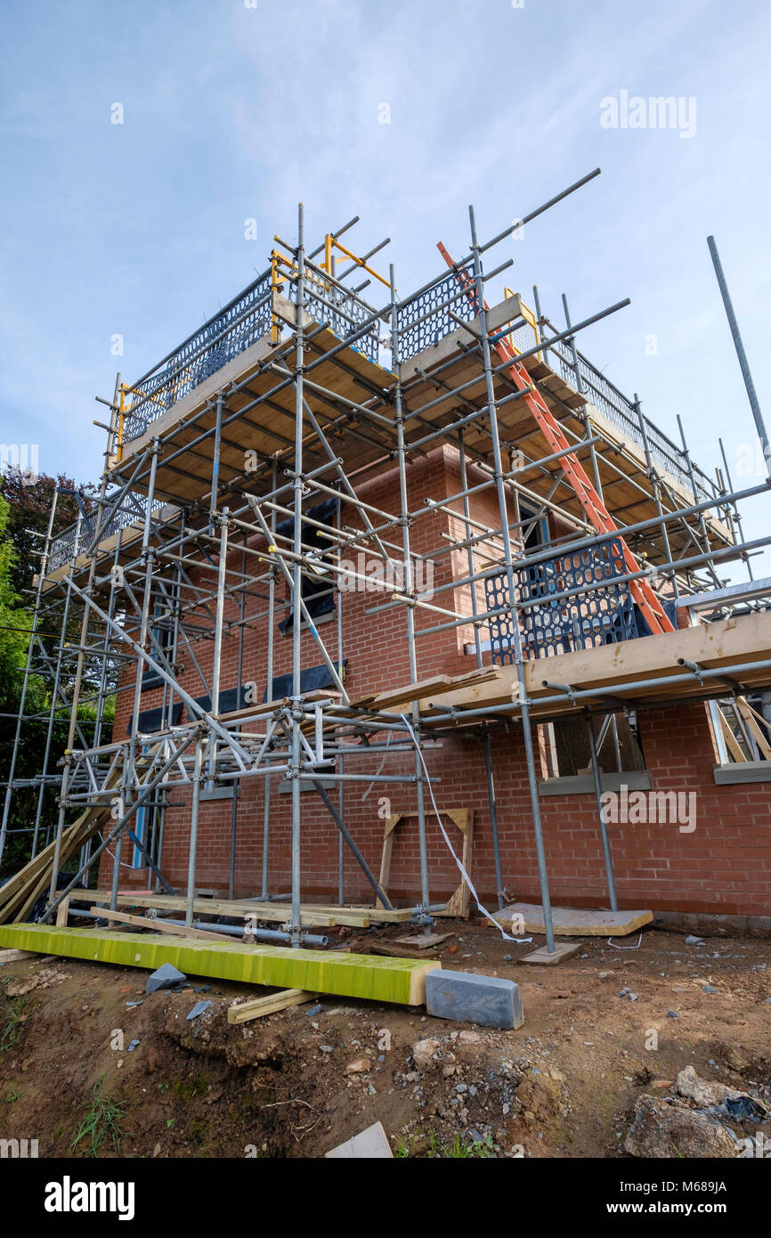 Extension being built on house. Scaffolding in place. Gloucestershire England UK Stock Photo