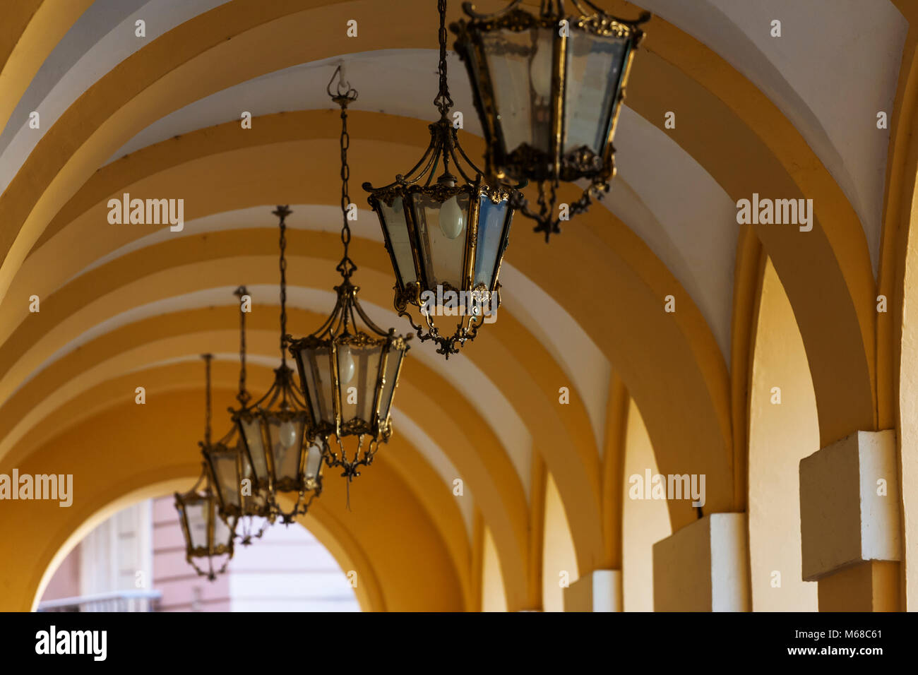 Lanterns under the frontal arcade of the Ayuntamiento (Town Hall), Plaza de San Juan de Dios, Cádiz, Andalusia, Spain Stock Photo