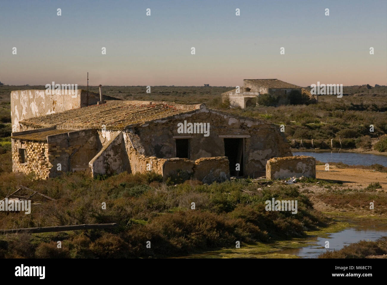 Ruined habitations in the saltmarshes of Bahia de Cadiz, near San Fernando, Andalusia Stock Photo