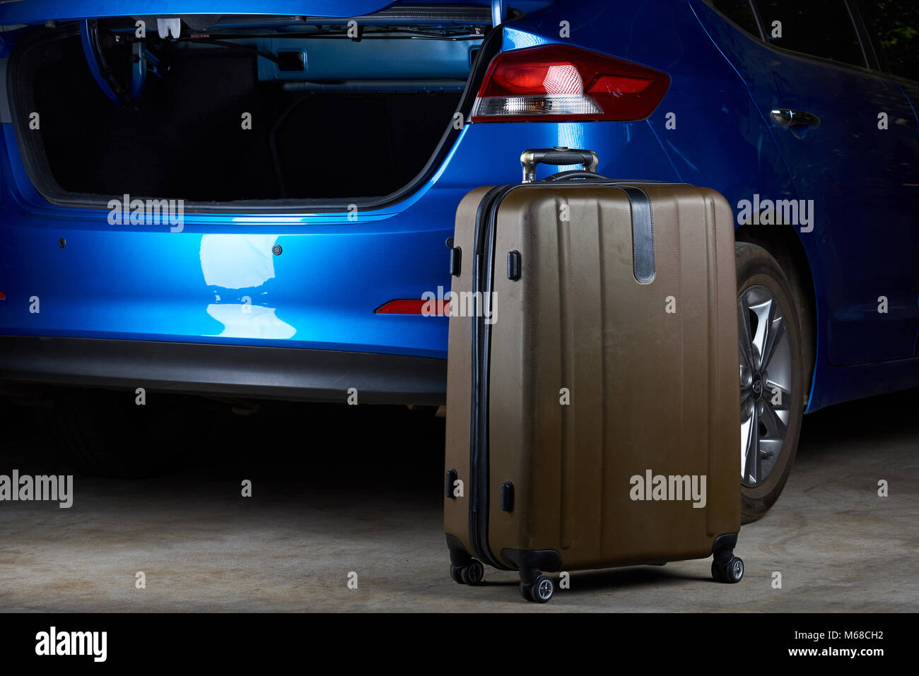 Open trunk of modern car. Luggage suitcase ready for loading Stock Photo