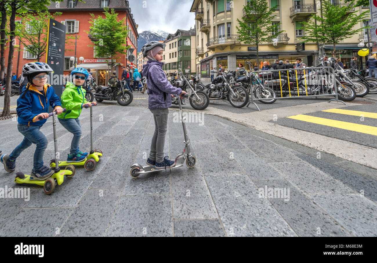 Children having fun on scooters Stock Photo