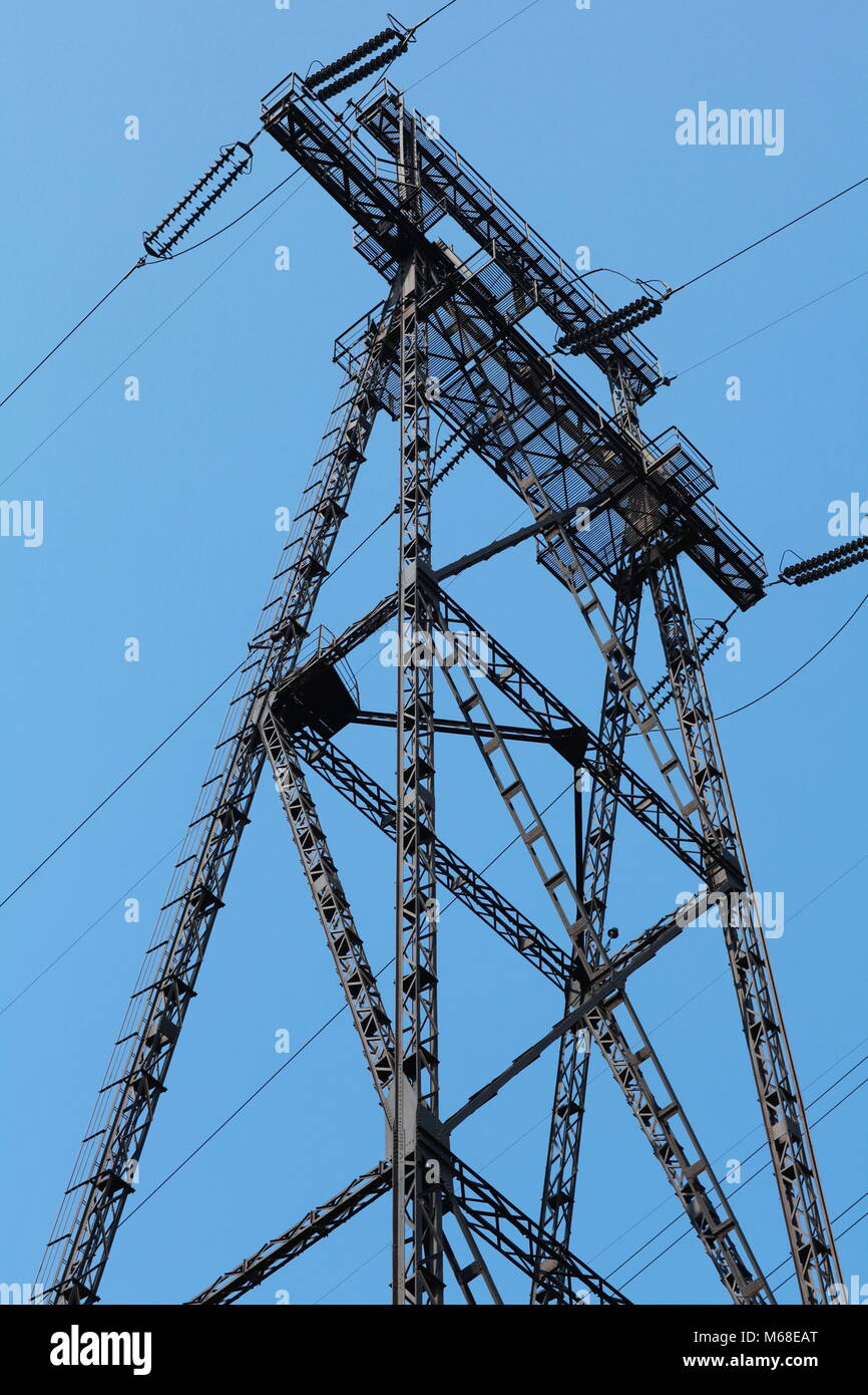 Power lines and electricity pylon against blue sky Stock Photo - Alamy