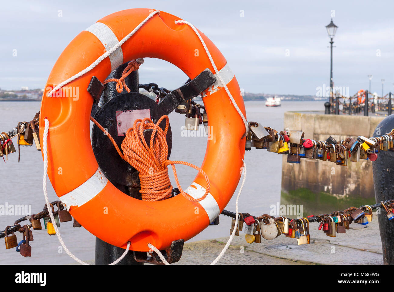 Love locks on a chain fence across a bridge. Albert Dock, Liverpool
