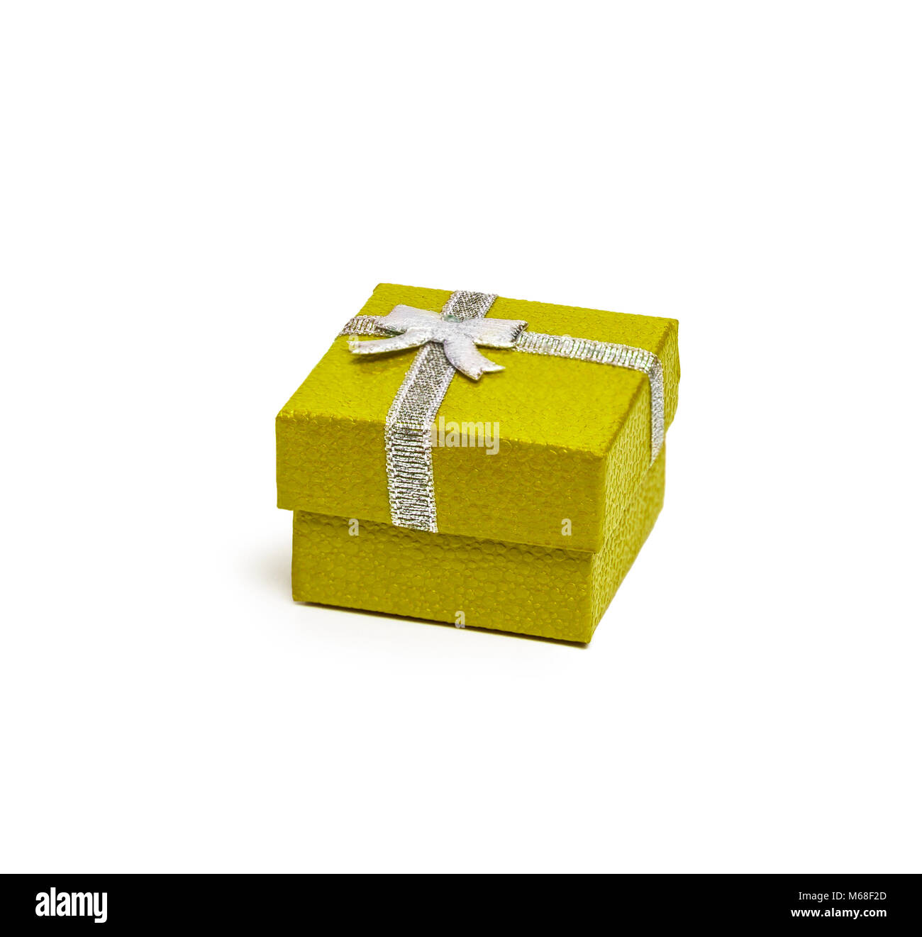 Yellow gift box with silver ribbon isolated on white background Stock