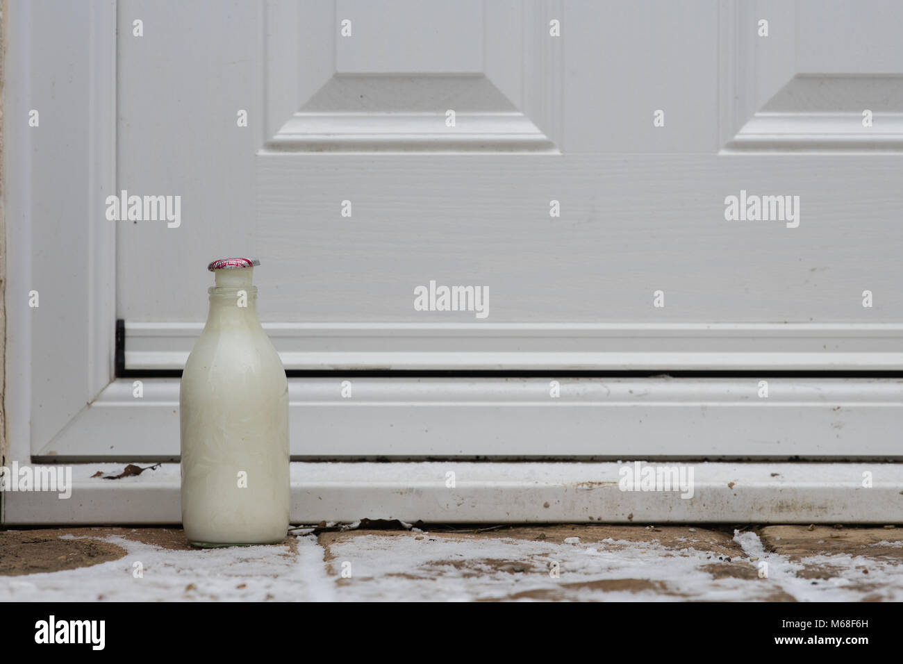 British Milk Bottle on Doorstep milk frozen Stock Photo Alamy
