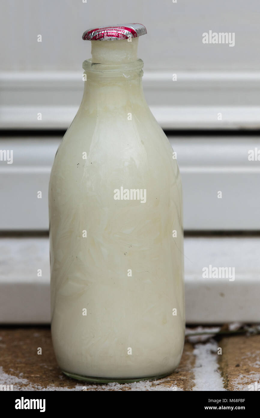 British Milk Bottle on Doorstep milk frozen Stock Photo Alamy