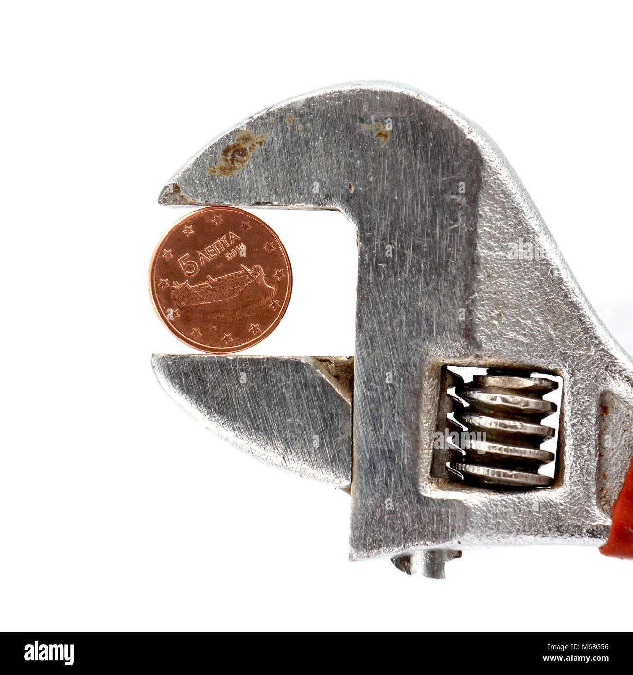 five euro cent coin pressed on adjustable wrench,image Stock Photo