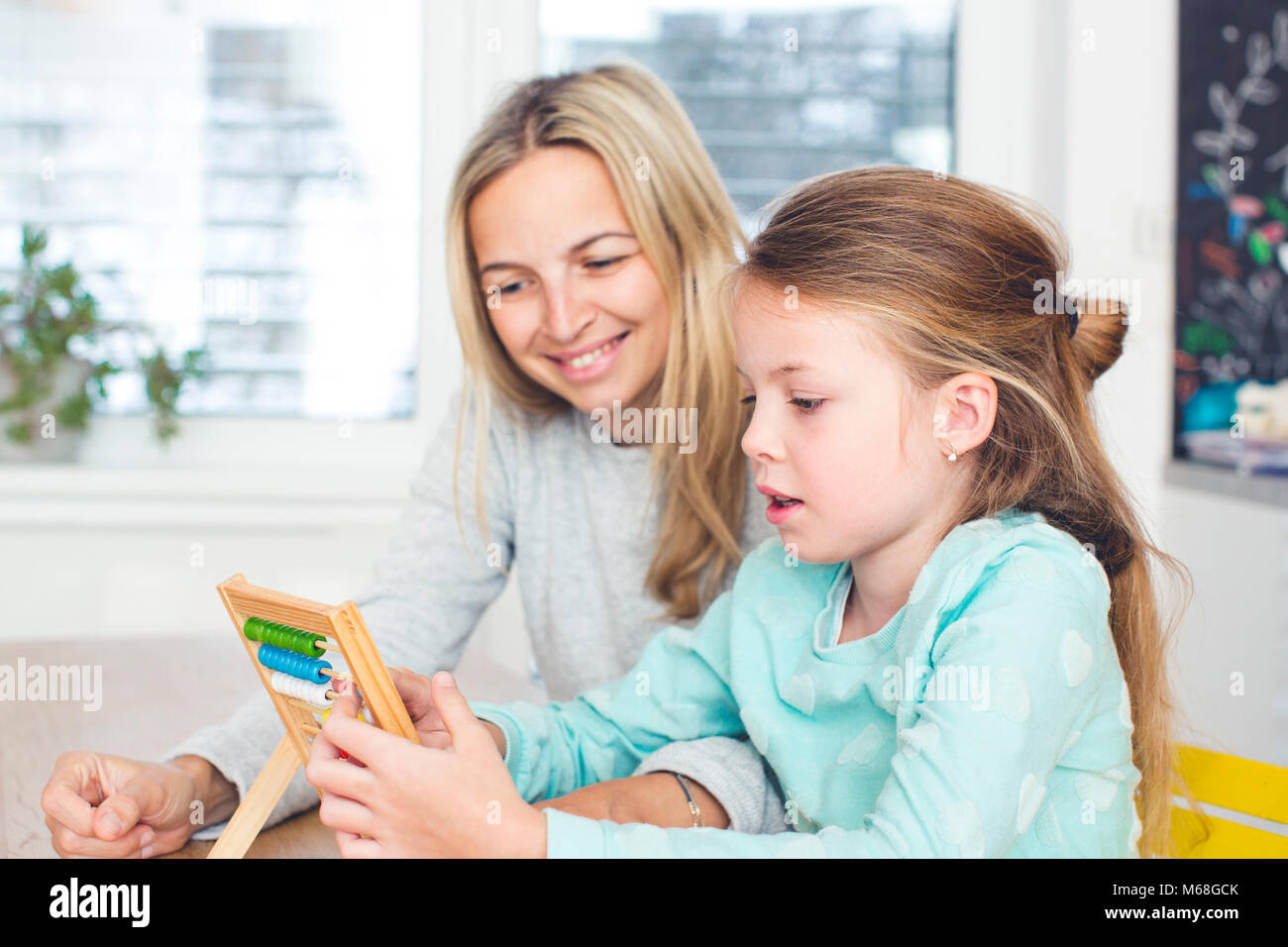 mother learns mathematics with the child using the calculator Stock ...