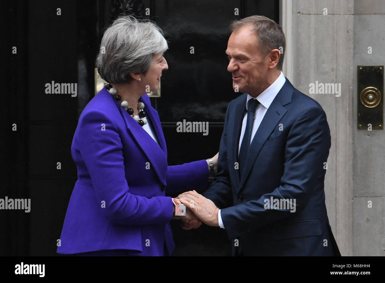 Prime Minister Theresa May greets European Council president Donald Tusk ahead of a meeting at Downing Street, London. Stock Photo