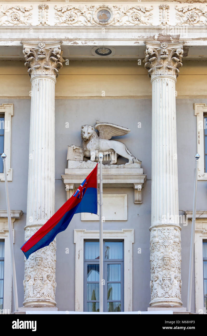Venetian winged lion sculpture and town flag on the facade of the town hall in Piran, Slovenia Stock Photo