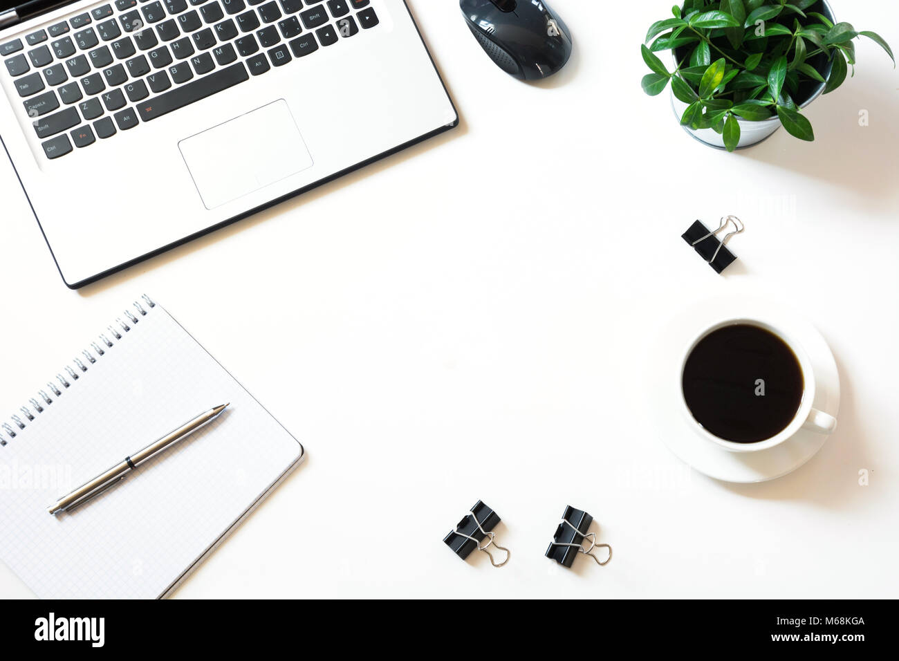 Open laptop on white office white desk table. Top view with copy space