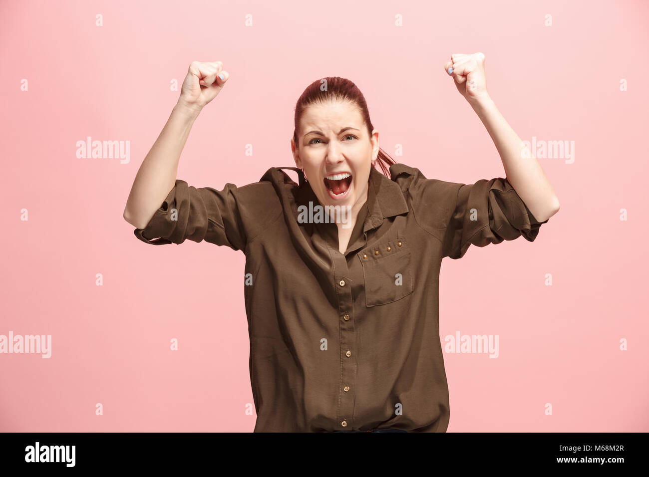 Winning success woman happy ecstatic celebrating being a winner. Dynamic energetic image of female model Stock Photo