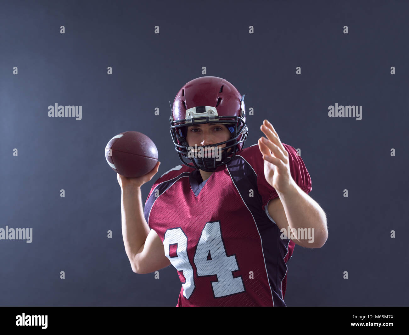 one quarterback american football player throwing ball isolated on gray