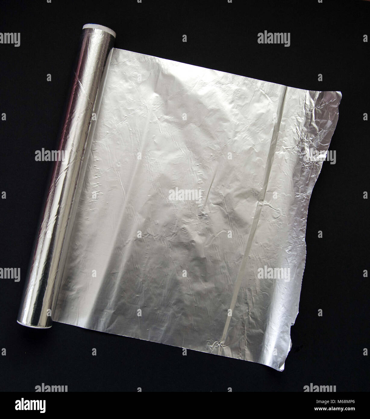 The aluminum foil used for cooking in the kitchen stands on the black floor Stock Photo Alamy