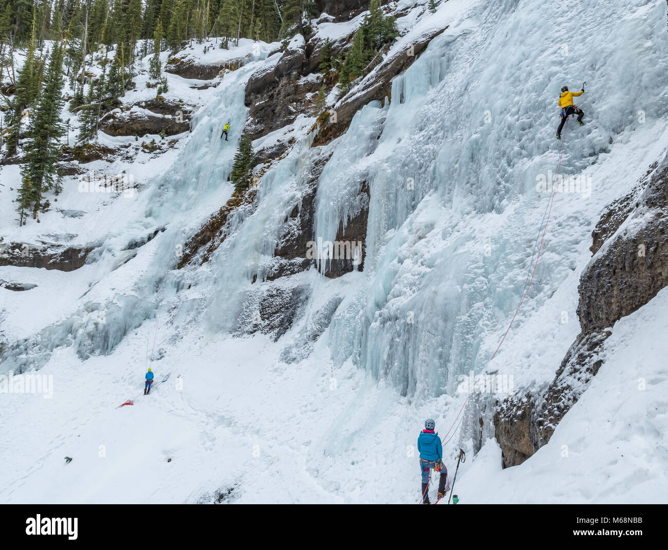 Elijah Weber and Matt Ward lead a route called Twin Falls in Hyalite Canyon Montana Stock Photo