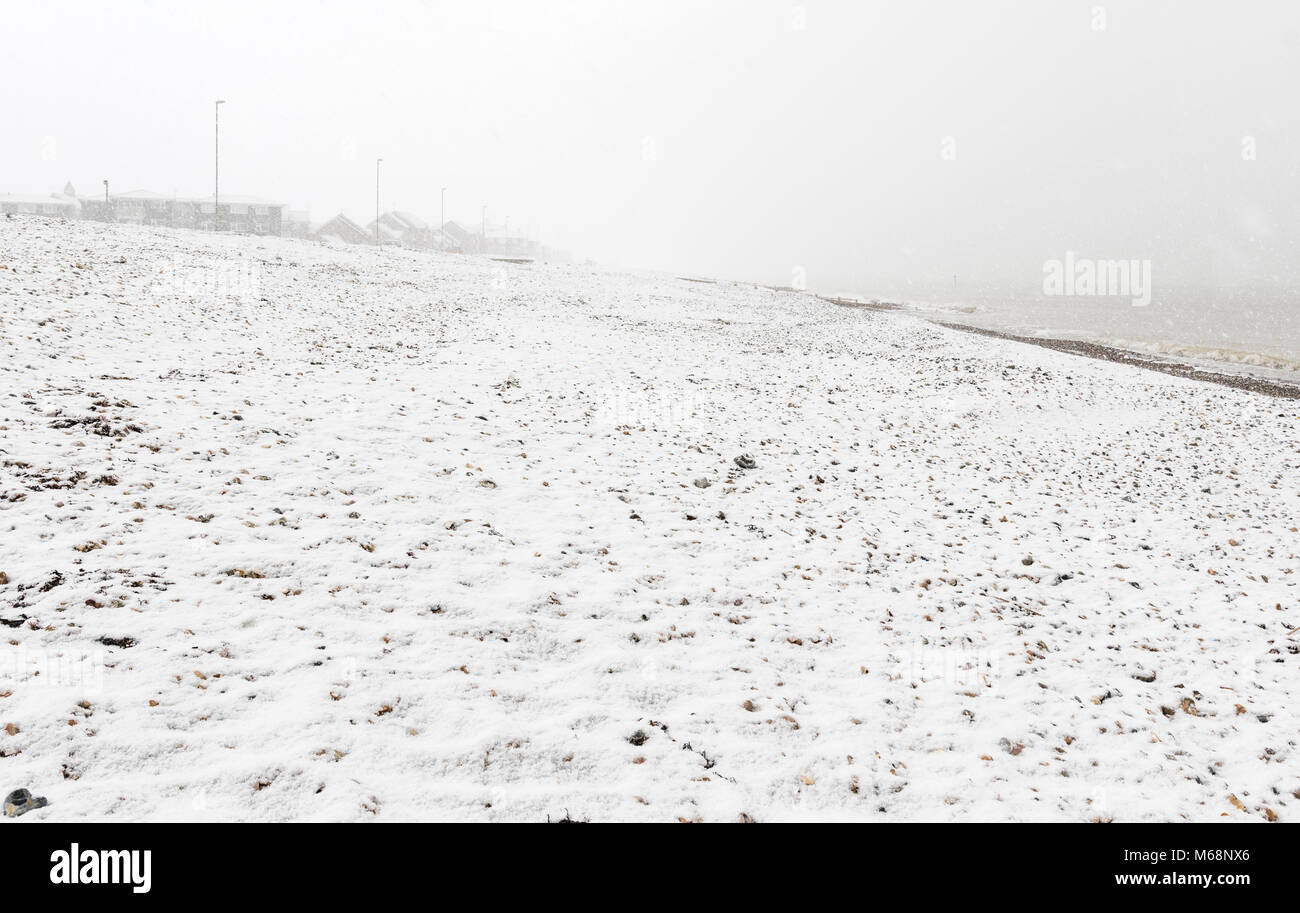 Snow covered deserted beach in Winter in Littlehampton, West Sussex, England, UK. Stock Photo