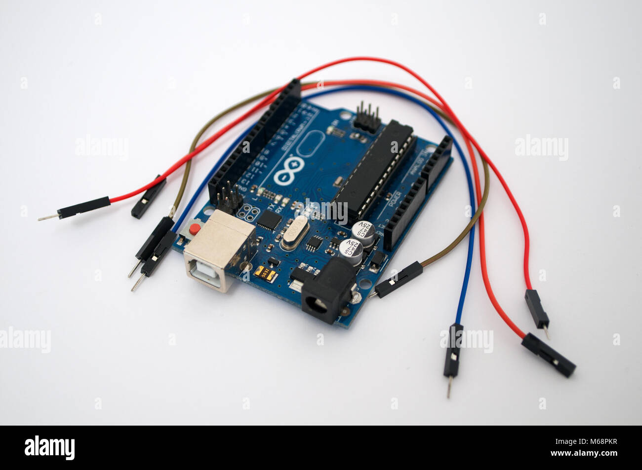 Arduino, wires and around transistors lined up on a white background ...