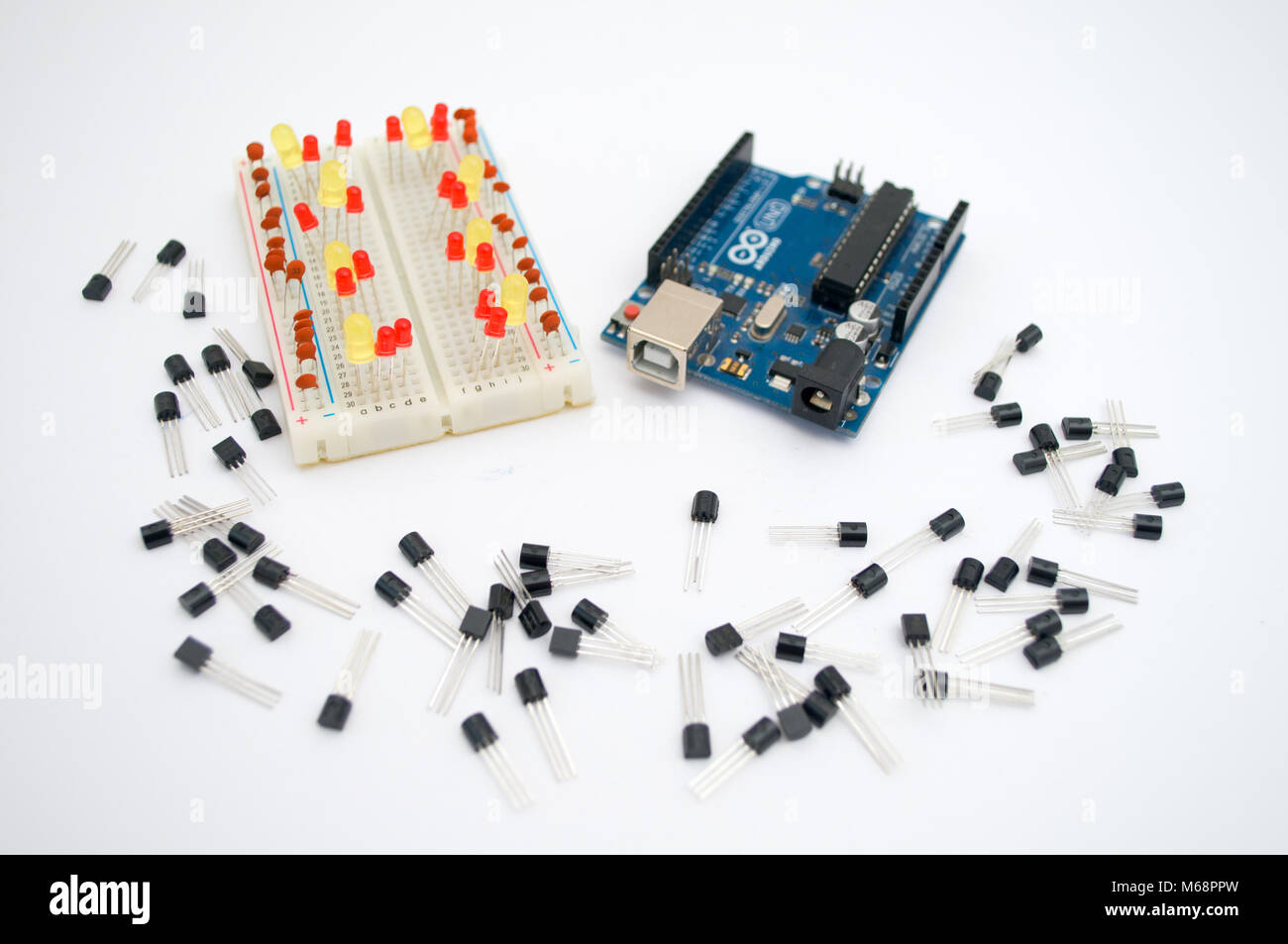 Arduino, wires and around transistors lined up on a white background ...