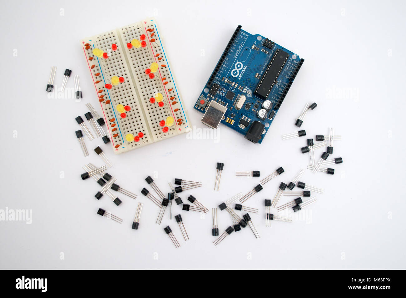 Arduino, wires and around transistors lined up on a white background ...
