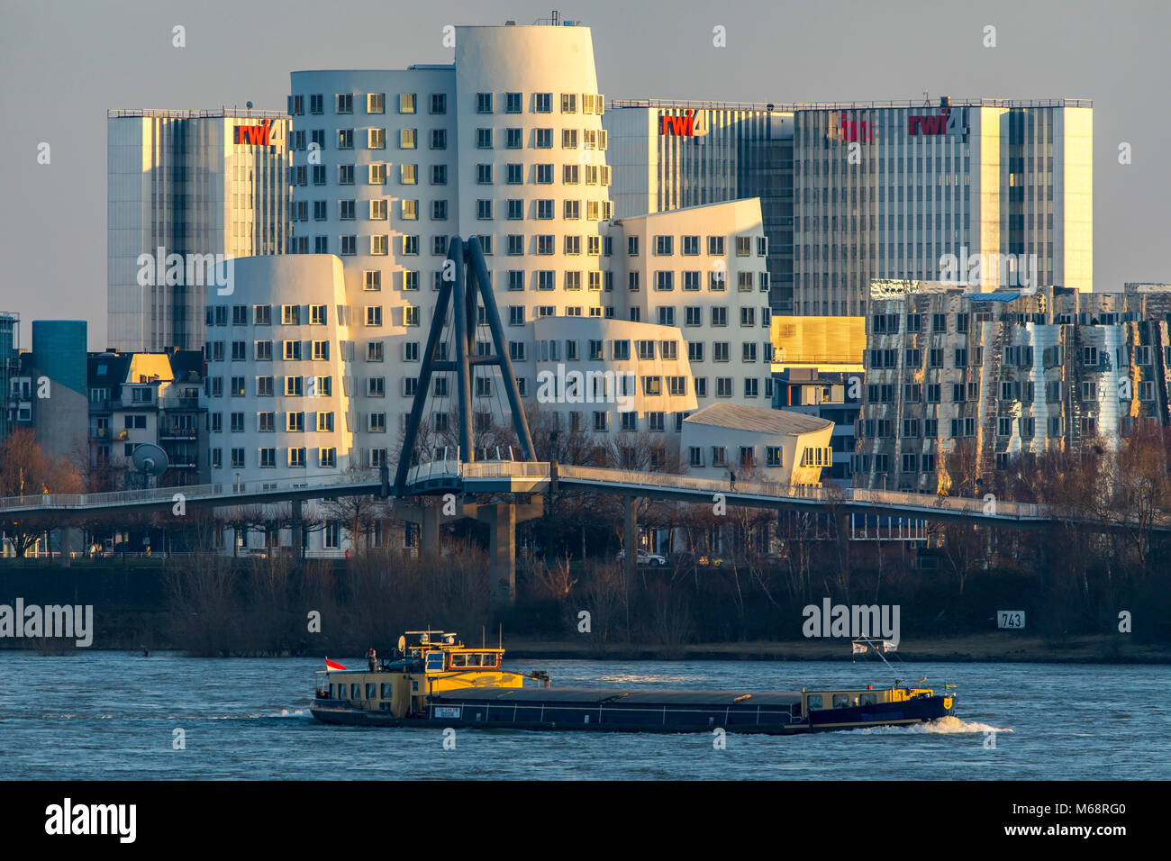 Düsseldorf, Germany, the Gehry buildings, Neuer Zollhof, in the Medienhafen, Media port district,  behind the RWI4 building complex, river Rhine, carg Stock Photo