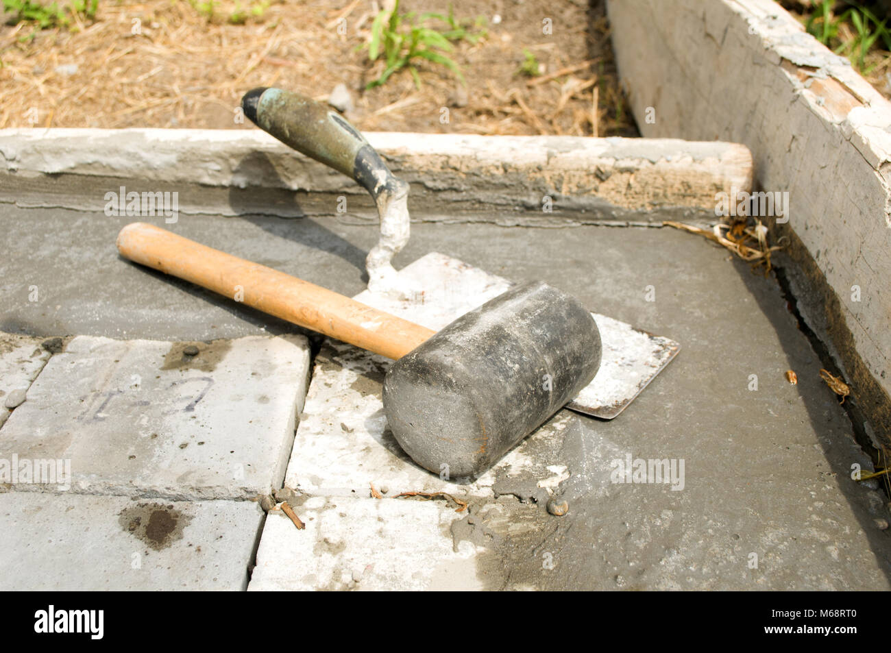 Trowel and hammer on concrete blocks Stock Photo Alamy