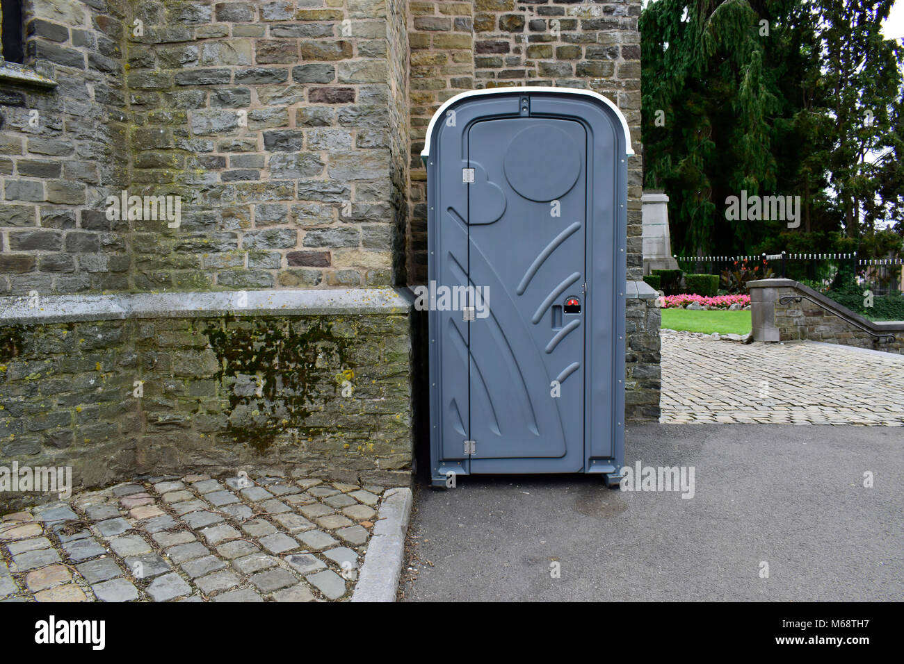 Portable toilet cabins or mobile toilet on the road and wall background. Stock Photo